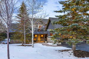 View of snow covered exterior featuring a balcony