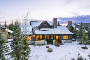 View of snow covered back of property