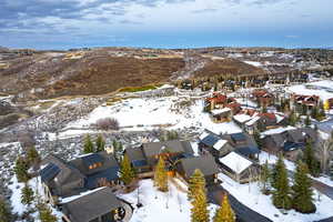 Snowy aerial view featuring a mountain view