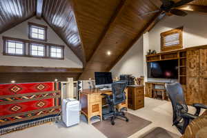 Carpeted office with lofted ceiling with beams, ceiling fan, and wood ceiling