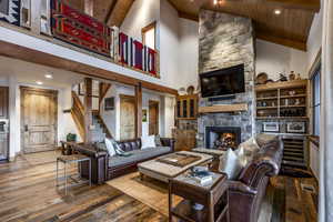 Living room with wood-type flooring, high vaulted ceiling, and wood ceiling