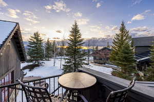 View of snow covered back of property