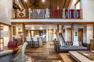 Living room featuring hardwood / wood-style floors, beamed ceiling, and wooden ceiling