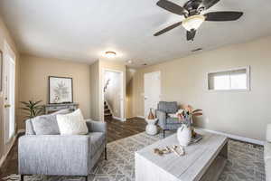 Living room featuring ceiling fan and dark hardwood / wood-style flooring