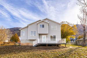 Back of property with a deck with mountain view