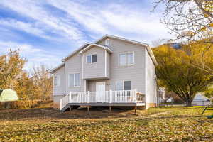 Rear view of property featuring a wooden deck