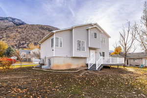 Back of property with a deck with mountain view