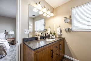 Bathroom featuring vanity and a wealth of natural light