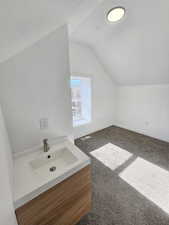 Bathroom featuring lofted ceiling