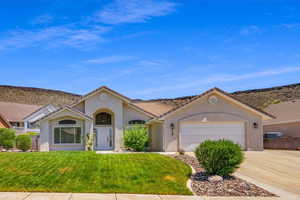 View of front of house featuring a front lawn and a garage