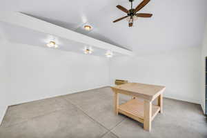 Interior space featuring ceiling fan and lofted ceiling