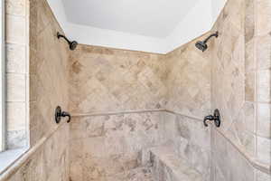 Room details with a tile shower