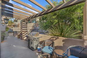 View of patio with a pergola and grilling area