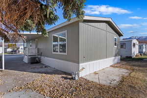 View of home's exterior with a mountain view and central AC unit