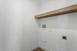 Laundry area with electric dryer hookup, washer hookup, and dark hardwood / wood-style floors