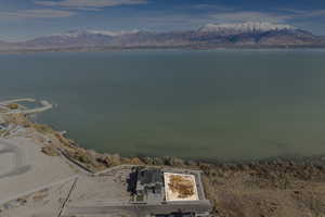 Birds eye view of property featuring a water and mountain view