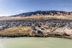 Drone / aerial view featuring a water and mountain view