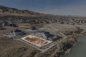 Birds eye view of property with a water and mountain view