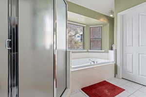 Bathroom with plus walk in shower and tile patterned floors