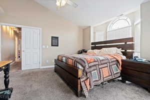 Bedroom featuring carpet flooring, ceiling fan, and vaulted ceiling