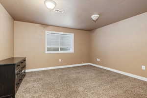 Unfurnished room featuring light colored carpet