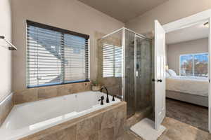 Bathroom featuring tile patterned floors and separate shower and tub