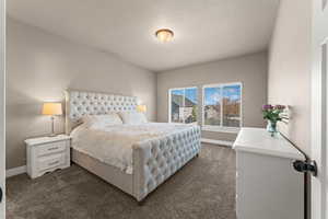 Carpeted bedroom with a textured ceiling