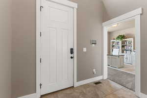 Entrance foyer with light carpet