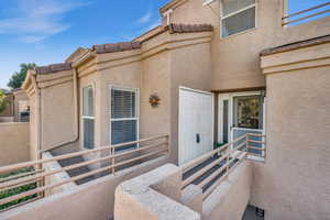 Entrance to property with a balcony