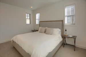 Bedroom with light colored carpet