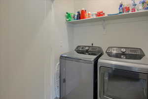 Washroom featuring separate washer and dryer