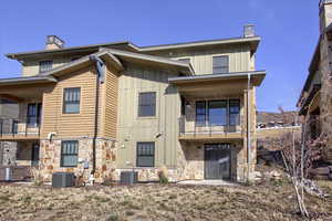 View of front of property with a balcony and cooling unit