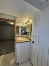 Bathroom featuring vanity and wood walls