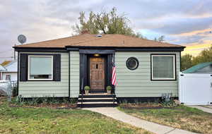 Bungalow-style home with a lawn