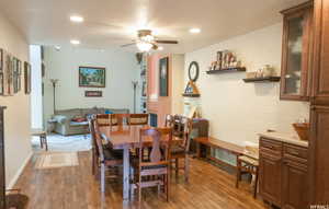 Dining room featuring a textured ceiling, ceiling fan, and dark wood-type flooring