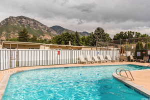 View of pool with a mountain view and a patio area