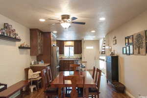 Dining room with sink, dark wood-type flooring, and a textured ceiling