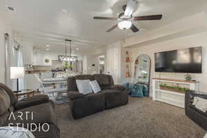 Carpeted living room with ceiling fan