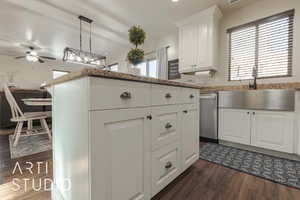 Kitchen featuring hanging light fixtures, dark hardwood / wood-style flooring, white cabinetry, and plenty of natural light