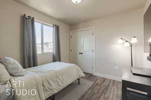 Bedroom featuring hardwood / wood-style flooring and a closet