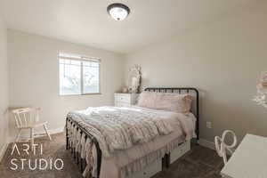 Bedroom featuring dark colored carpet