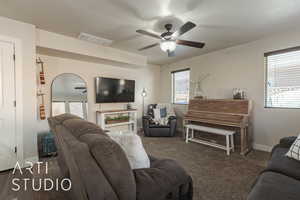 Carpeted living room with ceiling fan