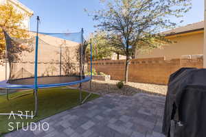 View of patio / terrace with a trampoline and grilling area