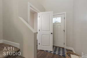 Entrance foyer with dark hardwood / wood-style floors