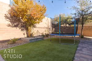 View of yard with a trampoline