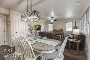 Dining area with ceiling fan and dark hardwood / wood-style flooring