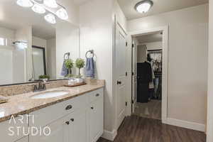 Bathroom with a shower, vanity, and hardwood / wood-style flooring