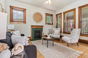 Living room with ceiling fan and light wood-type flooring