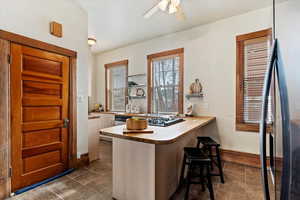 Interior space with ceiling fan and sink