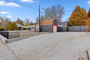 Exterior space featuring a garage and a storage shed